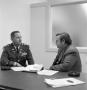 Photograph: [Army officer speaking with man]