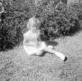 Photograph: [Carol sitting in the grass]