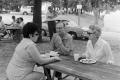 Photograph: [Adults sitting at a picnic table]