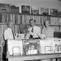 Photograph: [Men standing in a room of records]