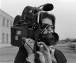 Primary view of [Photograph of a woman with a video camera]
