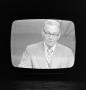 Photograph: [Frank Mills on a television screen]
