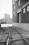 Photograph: [Photograph of train tracks running near a building]