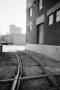 Photograph: [Photograph of train tracks running near a building, 2]