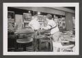 Photograph: [Photograph of two men at a bar table]