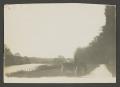 Photograph: [Individuals riding in a horse carriage]