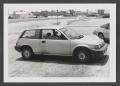 Photograph: [Photograph of a woman in a small car]