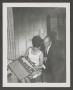 Photograph: [Doris and Byrd Williams III opening a Christmas gift]