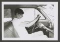 Photograph: [Photograph of a teenage boy in the driver's seat of an automobile]