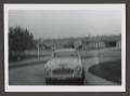Photograph: [Photograph of an automobile parked in a curved driveway]