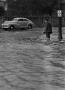 Primary view of [Man standing in a flooded street]