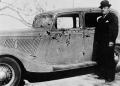 Photograph: [Man next to Bonnie and Clyde's car, 2]