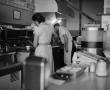 Photograph: [Susie Morgan and a cook in the kitchen]