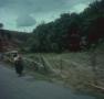 Primary view of [Native woman walking along the highway]