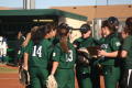 Photograph: [UNT softball players standing on field]
