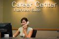 Photograph: [Worker on phone at the Interview Suite desk]