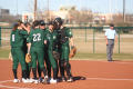 Photograph: [UNT players huddled in pitcher's circle]