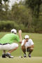 Primary view of [Austin Welch and other player crouched on green]