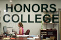 Photograph: [Honors College office worker at desk]