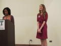 Photograph: [Cara Walker speaking at podium with April Kuykendall 1]