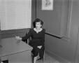 Photograph: [Photograph of Doris sitting at a table at the Byrd studio]