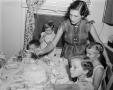 Photograph: [Photograph of Doris Williams serving children birthday cake]
