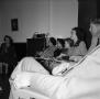 Photograph: [Photograph of individuals sitting in a row in a room]