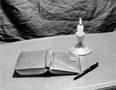 Photograph: [Photograph of a diary and a candle]