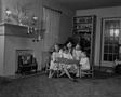 Photograph: [Doris reading to her children, 4]