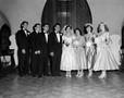 Photograph: [Bride and groom with their wedding party]