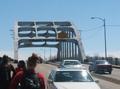 Photograph: [Cars and people at Edmund Pettus Bridge]