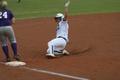 Photograph: [North Texas softball player slides to base during a game]