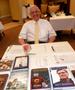 Primary view of [Man sits at literature table during TXSSAR Dallas Chapter meeting]