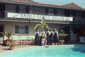 Photograph: [Photograph of waitstaff standing by pool]