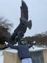 Photograph: [Student and UNT Soaring Higher statue during winter storm]