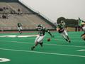 Photograph: [UNT football players on Fouts Field during 2002 Homecoming game]