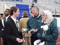 Photograph: [Young man converses with man and woman at 2002 UNT Homecoming game]