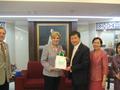 Photograph: [Man 2 receives gift from Gretchen Bataille at Thailand delegation me…