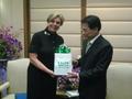 Photograph: [Man 4 receives gift from Gretchen Bataille at Thailand delegation me…