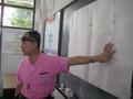 Photograph: [Man in front of chalkboard at Thailand school]