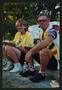 Photograph: [Cyclist and volunteer couple eating a meal on a curb: Lone Star Ride…