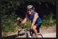 Photograph: [Cyclist Steve Rayl smiling and waving: Lone Star Ride 2002 event pho…