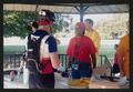 Primary view of [Cyclists talking to a medical team member: Loner Star Ride 2002 event photo]
