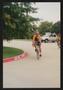 Photograph: [Cyclist in yellow rounding a corner: Lone Star Ride 2004 event photo]