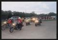 Photograph: [Group of motorcyclists turning their headlights on: Lone Star Ride e…