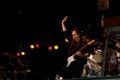 Primary view of [John McFee waves during Doobie Brothers performance]