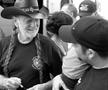 Primary view of [Willie Nelson signs autographs before BioWillie press conference]