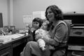 Photograph: [Concha Neeley with her children in UNT office]