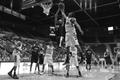Photograph: [UNT men's basketball player blocks Troy player's shot]