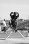 Photograph: [UNT men's track member performs long jump at Mean Green Twilight Inv…